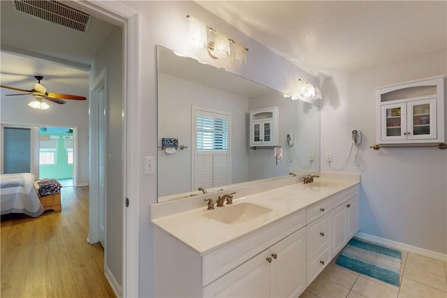 bathroom with ceiling fan, vanity, and tile patterned flooring