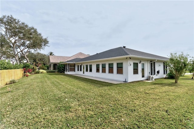 rear view of house with a lawn