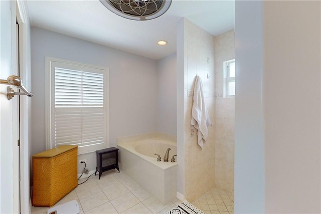 bathroom featuring plus walk in shower, tile patterned floors, and plenty of natural light