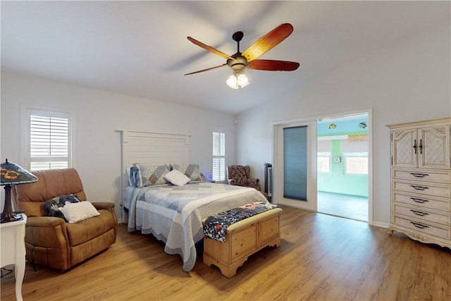 bedroom featuring ceiling fan, lofted ceiling, light hardwood / wood-style floors, and multiple windows