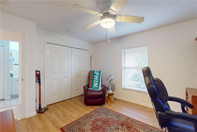 home office featuring light hardwood / wood-style floors and ceiling fan