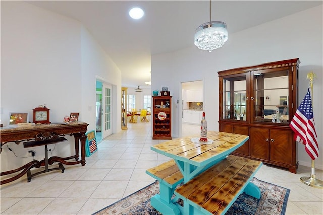 tiled dining area featuring vaulted ceiling and a notable chandelier