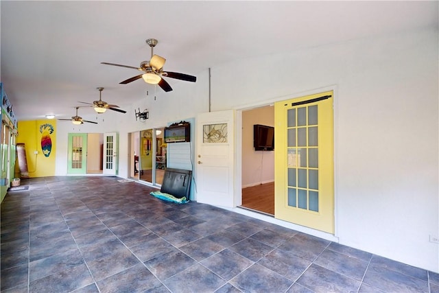 unfurnished living room with ceiling fan and lofted ceiling