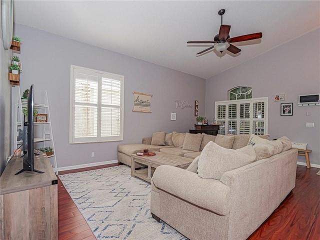 living room featuring lofted ceiling, wood-type flooring, and ceiling fan