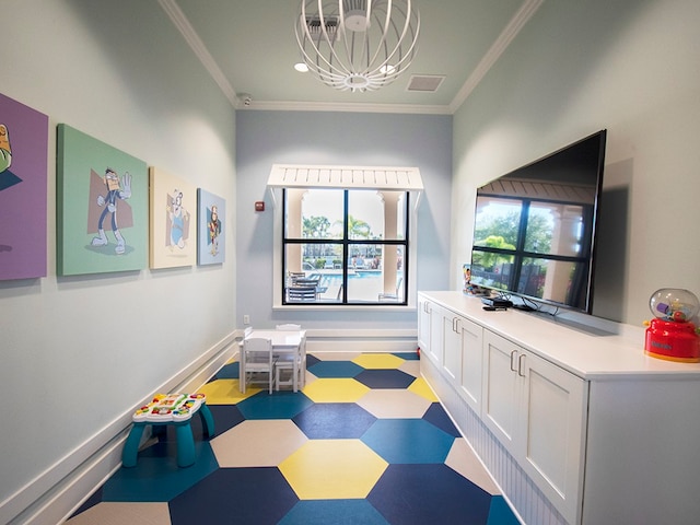 rec room with crown molding and a chandelier