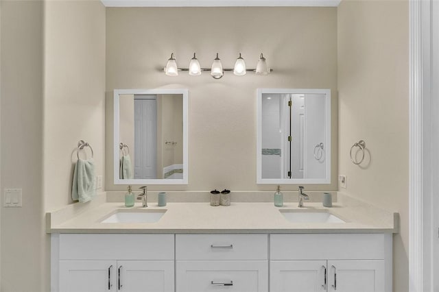 full bathroom with double vanity and a sink