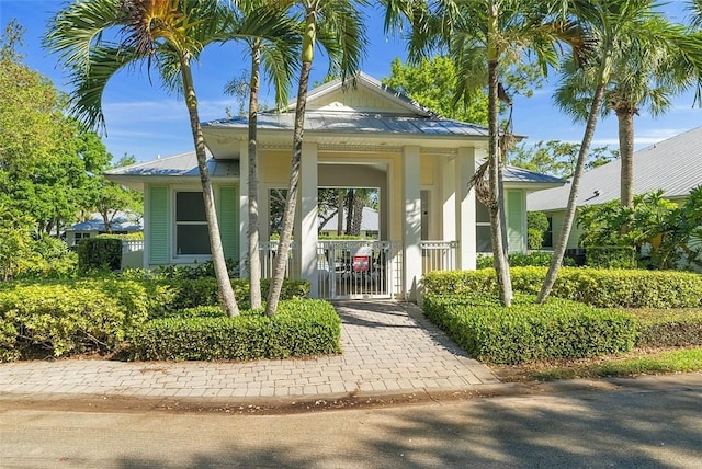 exterior space featuring metal roof and a gate