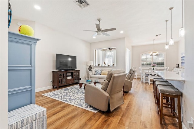 living room featuring recessed lighting, visible vents, and wood finished floors