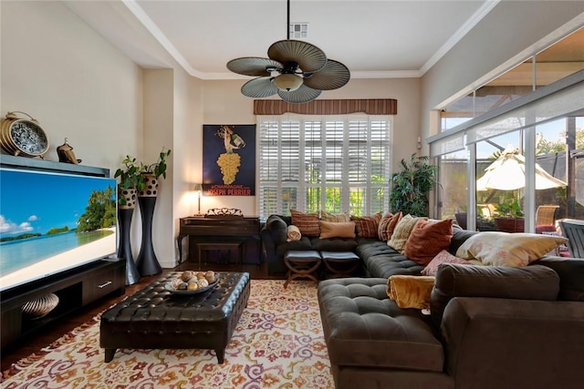 living room with hardwood / wood-style floors, ceiling fan, and ornamental molding