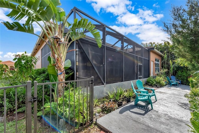 1781 Belmont Cir SW, Vero Beach, FL 32968 - rear view of house featuring a patio, stucco siding, and a lanai