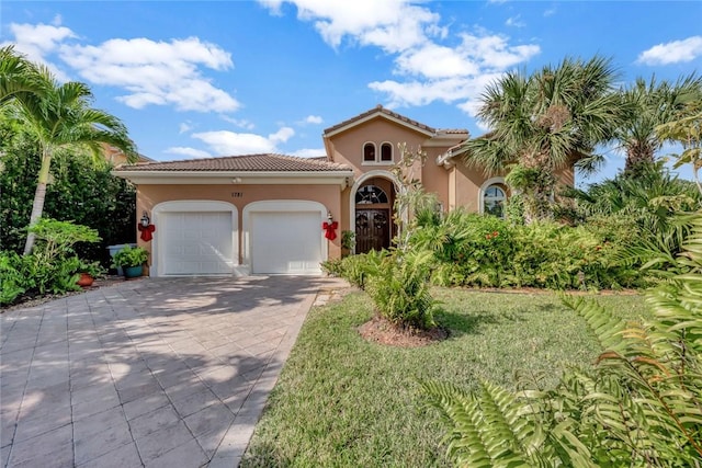 1781 Belmont Cir SW, Vero Beach, FL 32968 - mediterranean / spanish house with stucco siding, a garage, decorative driveway, and a tile roof