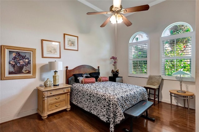 bedroom with ceiling fan, ornamental molding, dark wood-type flooring, and multiple windows