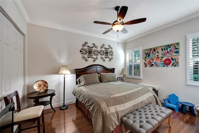 bedroom featuring a closet, dark hardwood / wood-style floors, ceiling fan, and crown molding