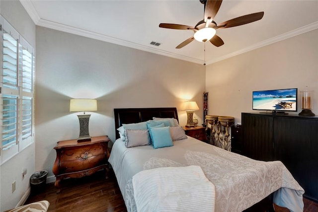 bedroom with ceiling fan, dark hardwood / wood-style floors, and ornamental molding