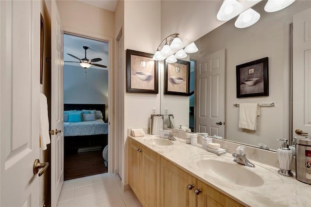 bathroom with tile patterned flooring, vanity, and ceiling fan