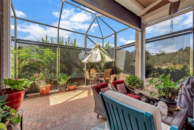 view of patio with outdoor lounge area and glass enclosure