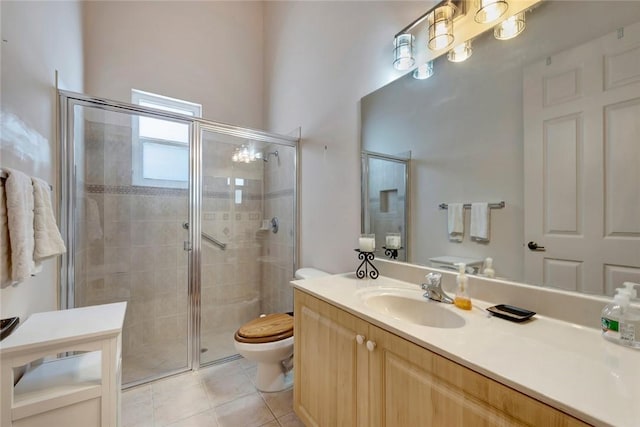 bathroom featuring toilet, tile patterned flooring, vanity, and walk in shower