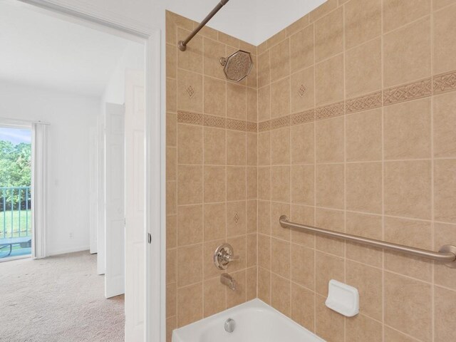 bedroom with ceiling fan, ensuite bathroom, and light colored carpet