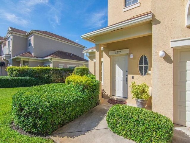 doorway to property featuring stucco siding