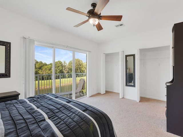 bedroom with light carpet, visible vents, ceiling fan, access to exterior, and two closets