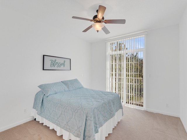 bedroom with ceiling fan, light colored carpet, and access to exterior