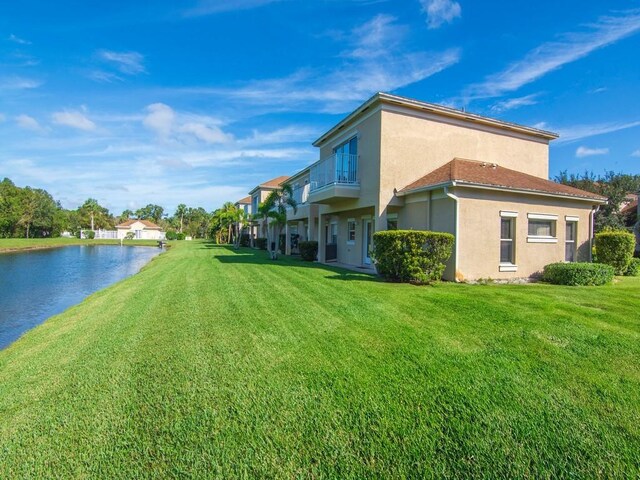 exterior space with a balcony and a water view