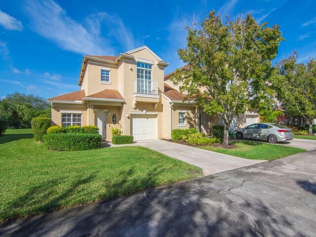 view of front of property with a front yard and a garage