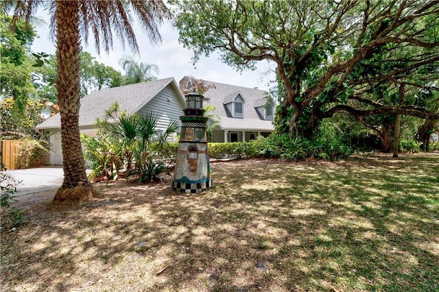 view of front of house featuring a garage and a front lawn