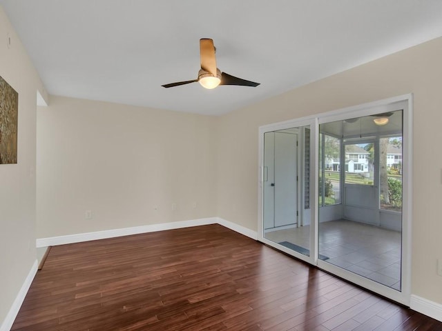 empty room with dark hardwood / wood-style floors and ceiling fan