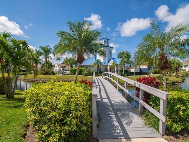 view of home's community with a yard and a water view