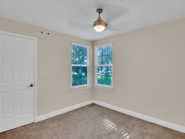 spare room featuring light colored carpet