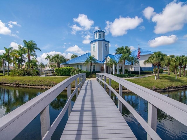 view of dock featuring a yard and a water view