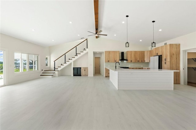 9670 Riverview Dr, Micco, FL 32976 - unfurnished living room featuring stairs, beamed ceiling, recessed lighting, light wood-style floors, and a ceiling fan