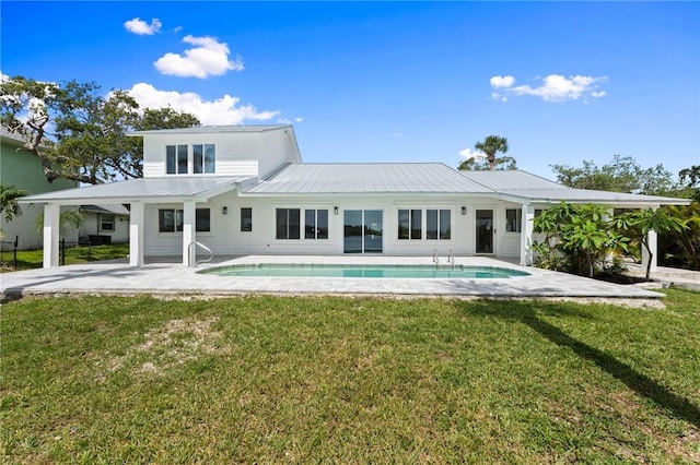9670 Riverview Dr, Micco, FL 32976 - back of house featuring an outdoor pool, a patio, and a lawn