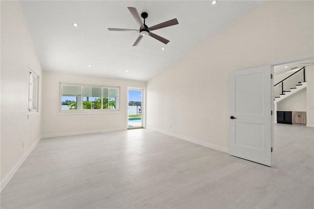 9670 Riverview Dr, Micco, FL 32976 - unfurnished room with light wood-style flooring, a ceiling fan, recessed lighting, high vaulted ceiling, and stairway