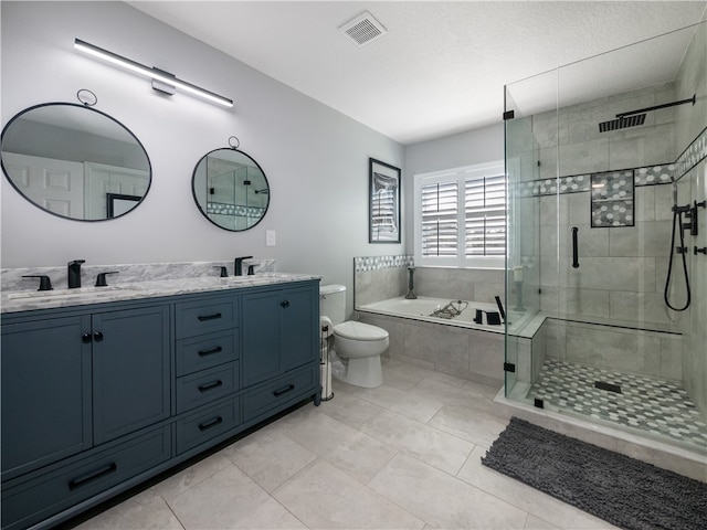 full bathroom featuring tile patterned floors, vanity, shower with separate bathtub, and toilet