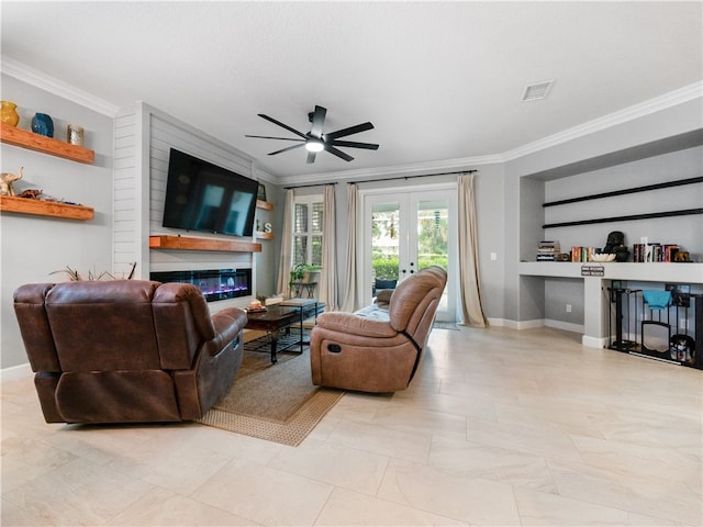 living room featuring french doors, a large fireplace, ceiling fan, and crown molding