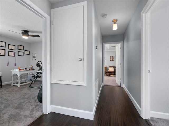 hall with dark wood-type flooring