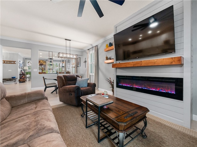 carpeted living room with ornamental molding, a fireplace, and ceiling fan