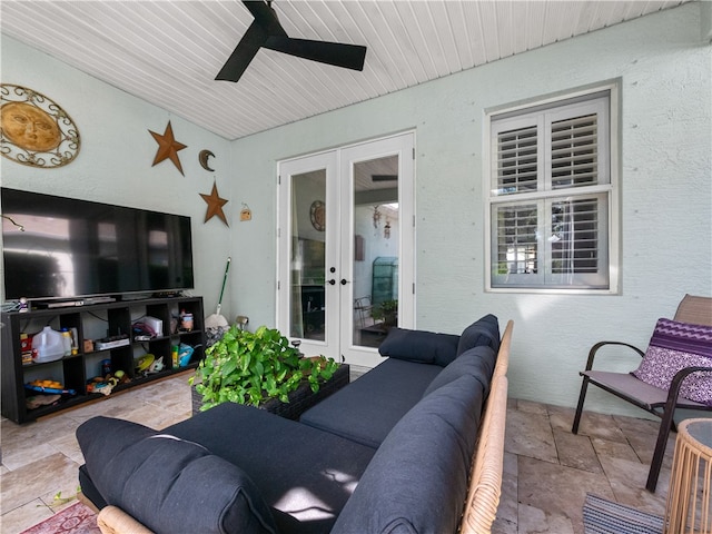 living room featuring french doors and ceiling fan