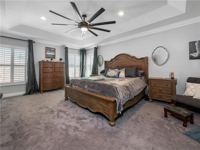 carpeted bedroom with ornamental molding, a textured ceiling, ceiling fan, and a raised ceiling