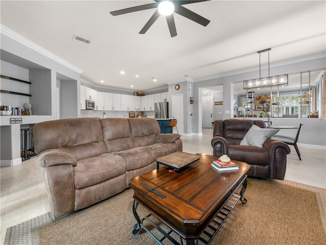 tiled living room featuring ornamental molding and ceiling fan