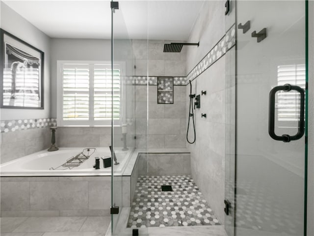 bathroom featuring shower with separate bathtub and tile patterned flooring