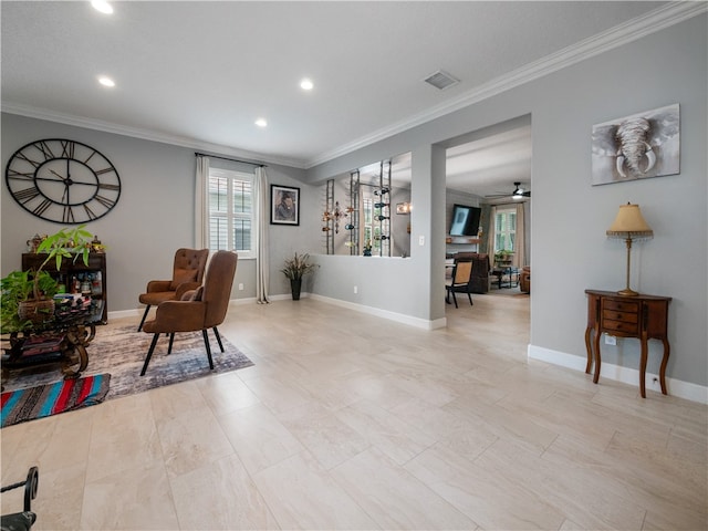 sitting room featuring ceiling fan and ornamental molding