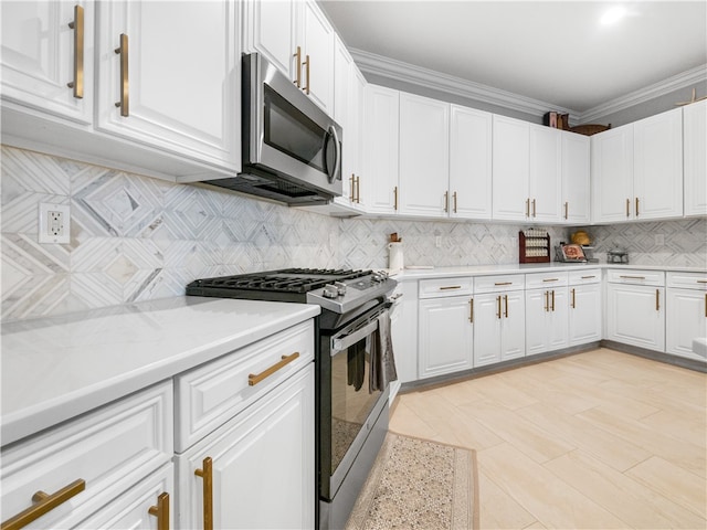 kitchen featuring white cabinets, crown molding, and stainless steel appliances