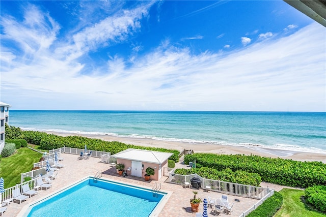 exterior space featuring a beach view and a water view