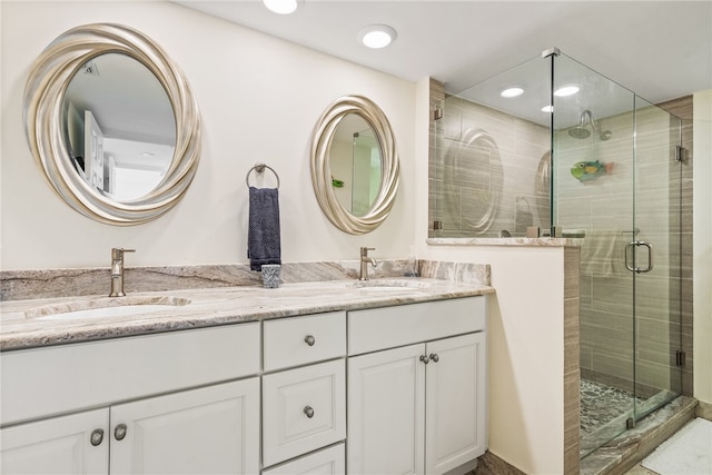 bathroom featuring walk in shower and vanity