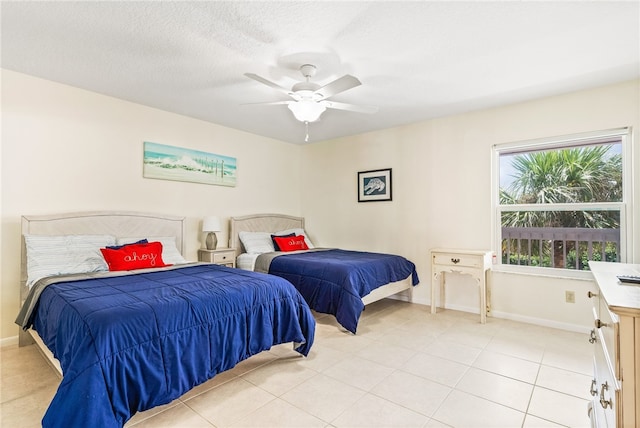 tiled bedroom with a textured ceiling and ceiling fan