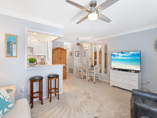 carpeted living room featuring ceiling fan with notable chandelier and crown molding