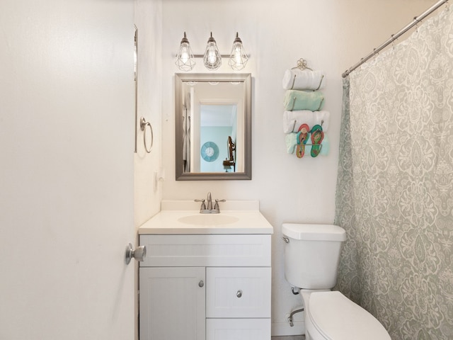 bathroom featuring toilet and vanity